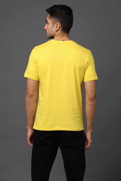 Man wearing a yellow t-shirt on a gray background