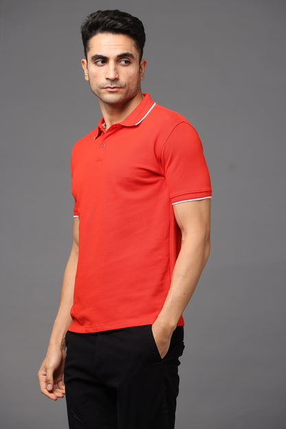 Man wearing a red polo shirt against a gray background